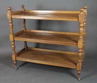 A Victorian light oak rectangular 3 tier buffet, raised on turned and block supports 44"h x 48"w x 19"d 