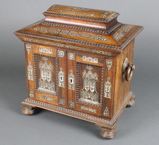 A Victorian rosewood and inlaid mother of pearl ladies travelling/writing box of sarcophagus form with hinged lid and 2 ring drop handles to the sides, enclosed by panelled doors revealing a fitted interior, 1 long drawer, a jewel drawer and a writing slope drawer, raised on turned supports, 13"h x 13 1/2"w x 9"d
