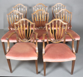 A set of 8 Hepplewhite style dining chairs with shield shaped backs and upholstered seats, raised on square tapering supports
