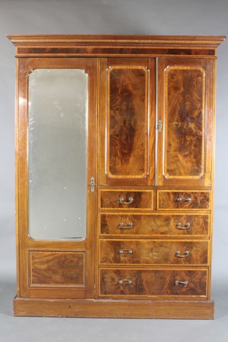 An Edwardian inlaid mahogany combination wardrobe with moulded cornice fitted a hanging compartment enclosed by a bevelled plate mirrored door, flanked by a cupboard enclosed by a panelled door above 2 short and 3 long drawers with brass swan neck drop handles 83"h x 62"w x 32"d 