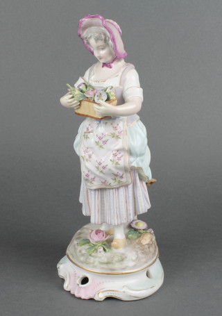 A 19th Century Continental figure of a flower seller on a raised rococo base 11" 
