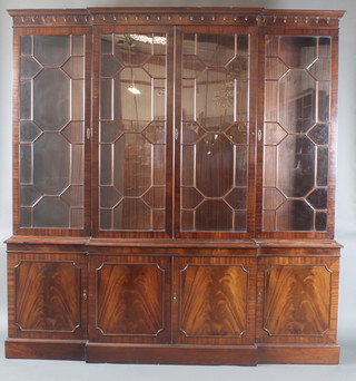 A Georgian style mahogany triple breakfront library  bookcase, the upper section with moulded cornice, the interior fitted adjustable shelves enclosed by astragal glazed panelled doors, the base fitted 4 cupboards, raised on a platform base 86"h x 82"w x 15"d 