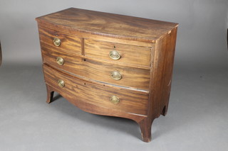 A Georgian mahogany bow front of 2 short and 2 long drawers with brass escutcheons and oval brass plate drop handles, raised on bracket feet 31"h x 40"w x 19 1/2"d 