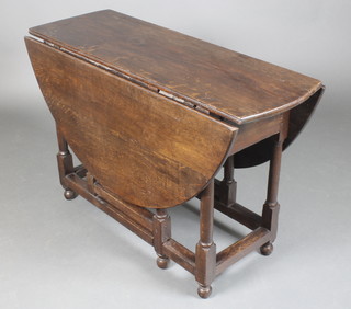 A 17th/18th Century oval drop flap gateleg dining table fitted a frieze drawer and raised on turned supports 26 1/2"h x 14" when closed x 42" when open x 49"w  