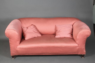 A drop arm Chesterfield upholstered pink material, raised on cabriole supports 27"h x 65"w x 29"d 