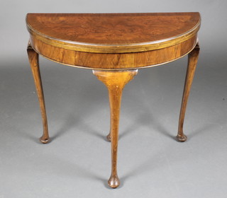 A 1930's figured walnut Queen Anne style bow front card table with crossbanded top, raised on cabriole supports 27"h x 32"w x 15"d  