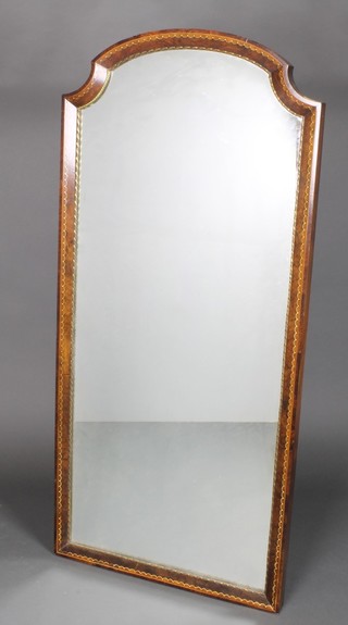 A Continental arch shaped plate mirror contained in an inlaid walnut and ormolu mounted frame 54" x 25"
