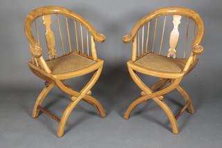 A pair of Chinese carved hardwood stick and tub back chairs with woven rush seats, raised on X framed supports 