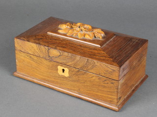 A Victorian carved rosewood trinket box of sarcophagus form with hinged lid, the top carved a floral arrangement, the interior fitted a tray 3 1/2" x 9 1/2" x 5 1/2" 