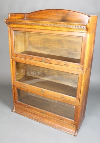 A 1930's oak Globe Wernicke style 3 tier bookcase with three-quarter gallery and dentilled cornice, 50"h x 35"w x 14"