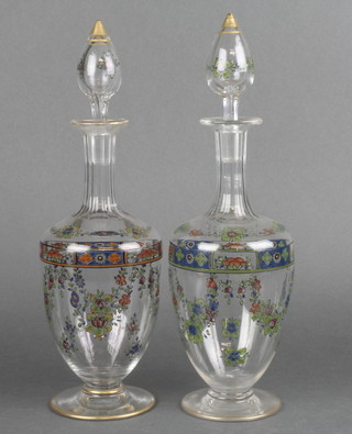 A pair of 19th Century Continental mallet shaped decanters and stoppers with floral and gilt decoration 14" 