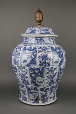 An early 19th Century Chinese blue and white baluster vase and cover decorated with lapet panels of landscapes and flowers 20" to top of vase 