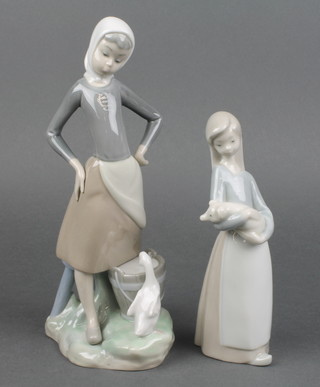 A Lladro figure of a goose girl 10", ditto of a girl holding a piglet 7" 