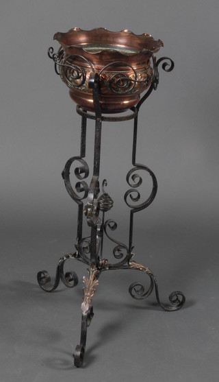 A Victorian circular repousse copper jardiniere, raised on a wrought iron base 34"h x 11 1/2" diam. 