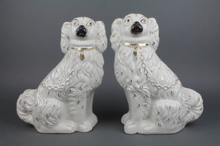 A pair of Staffordshire spaniels with gilt decoration.12"
