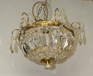 A circular gilt metal bag shaped light shade hung lozenges