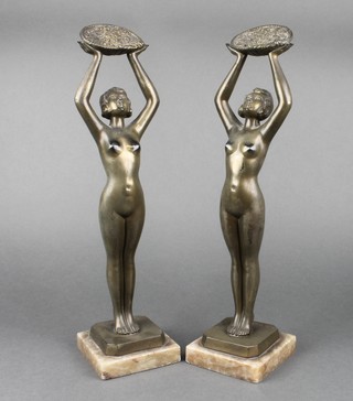 After Limouisn, a pair of Art Deco spelter and marble figures of standing naked ladies holding baskets, raised on marble bases 14"  