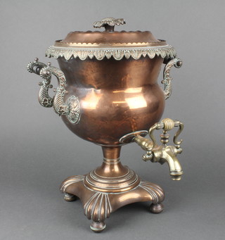 A 19th Century copper twin handled tea urn with brass spigot raised on 4 bun feet 