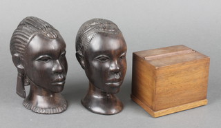 A 1930's rectangular mahogany cigarette dispenser 3"h x 3 1/2"w x 3"d together with 2 carved portrait busts of natives