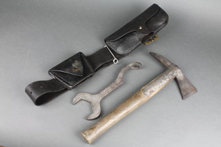 A fireman's axe complete with leather belt marked HFB (Horsham Fire Brigade) and spanner 