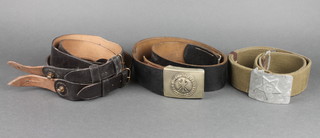 A Polish leather military belt with embossed buckle with eagle marked einigkeit recht freiheit , a Soviet Russian webbing belt with aluminium buckle and 2 Sam Brown shoulder belts