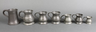 A Victorian pewter baluster shaped gill measure, a similar 1/2 pint measure,  4 other pewter measures and a waisted half pint tankard with glass base 