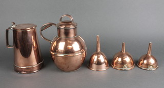 A waisted copper jug 6 1/2", a Jersey copper milk canister 7", 3 circular copper funnels 5", 3 1/2" and 3 1/2" 