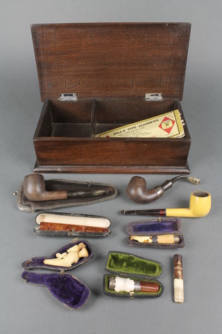 3 cigar holders (2f), a cheroot holder in the form of a standing lady (f) and 3 pipes contained in a wooden box with hinged lid