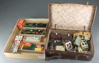 An attache case containing a case of plastic railway buildings, various plastic trees, fencing and other railway layout equipment 