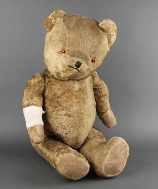 A 1940's yellow teddybear with articulated limbs 29", with bandaged arm