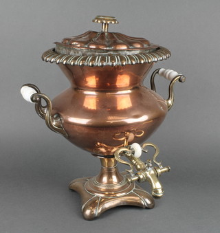 A 19th Century copper tea urn, raised on panelled support 16"h