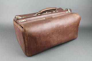 A brown leather Gladstone bag 8"h x 17 1/2"w x 10"d 