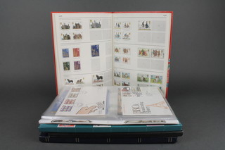 A Stanley Gibbons GB stamp album, a W H Smiths stock book of used stamps x 2 and a blue stock book of various used stamps together with a collection of first day covers 