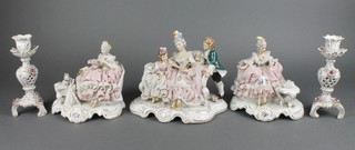 A pair of German figures of seated ladies on rococo bases 5", a similar group 8" and a pair of Continental candlesticks 4" 