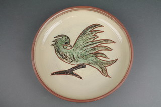 A Studio Pottery dish decorated with an exotic bird 14" 
