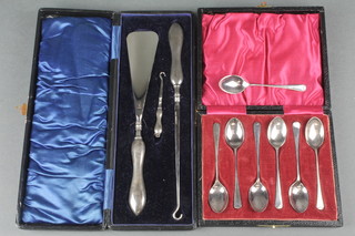 A cased 3 piece silver handled shoe horn, button hook set, Birmingham 1914 and 7 silver coffee spoons Sheffield 1925/1926 