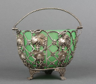 A Continental silver pierced sugar basket with vinous decoration on scroll feet with green glass liner, approx 164 grams
