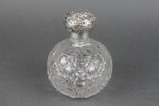 An Edwardian silver mounted baluster cut glass scent bottle with repousse lid, Birmingham 1905