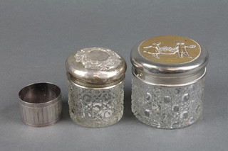 A Continental silver serviette ring, a silver topped toilet jar and 1 other 