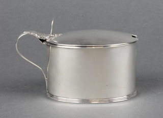 A George III silver oval mustard pot of plain form with blue glass liner 