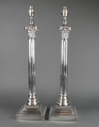A pair of silver plated Corinthian column table lamps on stepped bases 19" 