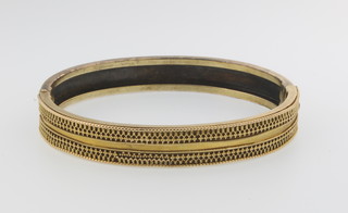 A Victorian  2 colour gold etruscan style bangle, 16 grams