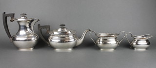 A 4 piece silver tea and coffee set with egg and dart decoration and ebony mounts, Sheffield 1949/1955/1956, gross weight 72 ozs 
