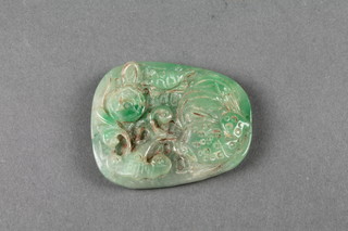 A carved jadeite pendant with stylised flowers 2 1/2" 