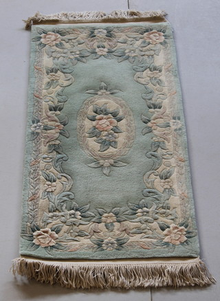 A green ground and floral patterned Chinese rug 51" x 24" 