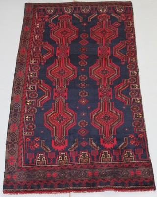 A Persian Balochi blue and red ground rug with stylised medallions to the centre 89" x 40"  