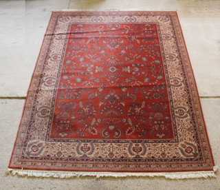 A Persian style machine made brown ground carpet with floral design 142" x 107 1/2"  