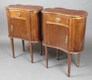 A pair of Edwardian Art Nouveau mahogany kidney shaped bedside cabinets with three quarter gallery, each fitted a drawer with cupboard enclosed by a panelled door, raised on square tapering supports, spade feet 30"h x 23"w x 12 1/2"d 