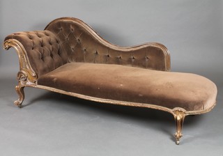 A Victorian carved mahogany show frame chaise longue with raised back, upholstered in brown buttoned dralon 29"h x 66"w x 25"d 