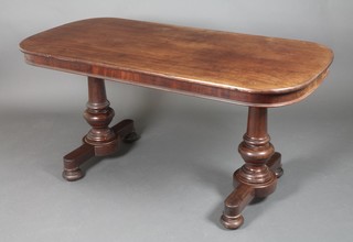 A Victorian oval mahogany library table, raised on turned supports 29"h x 60"w x 29"d